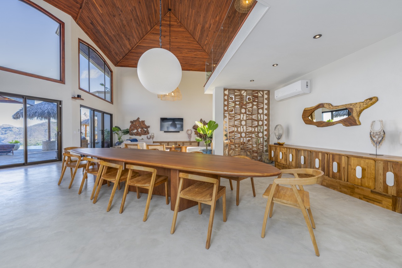 Casa Montaña dining and living space with a timber ceiling and large windows